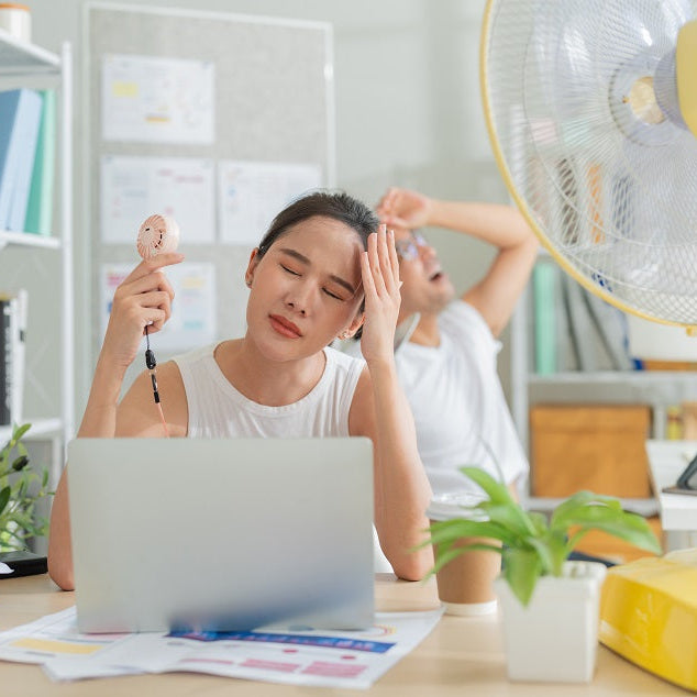 Women in office having hot flush