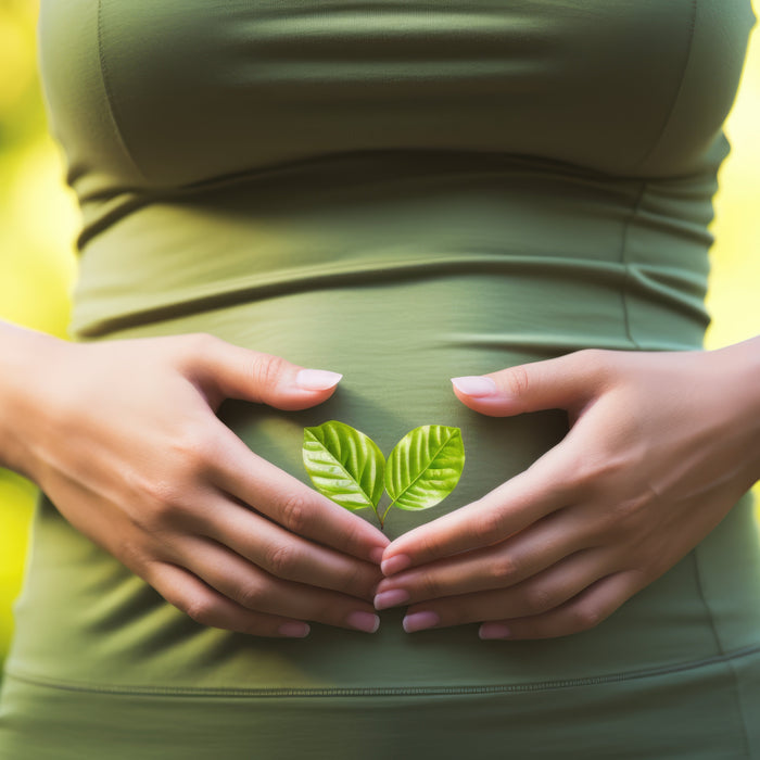 woman with hands in shape of heart over a stomach