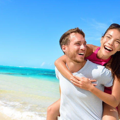 Healthy happy couple on beach
