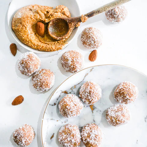 coconut covered protein bliss balls on plate