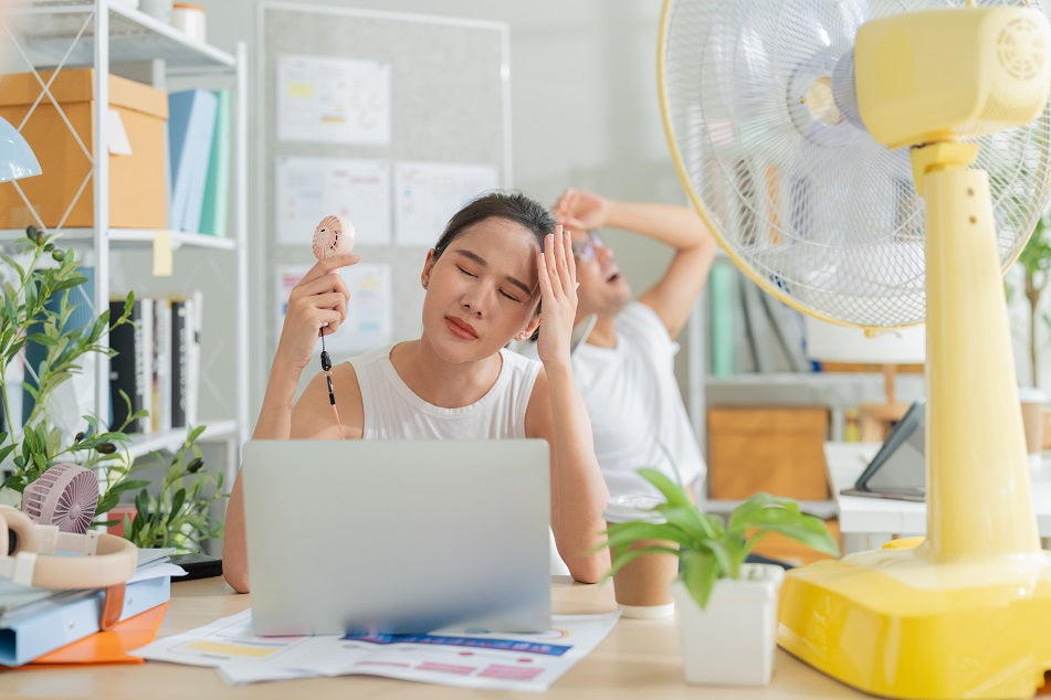 Women in office having hot flush