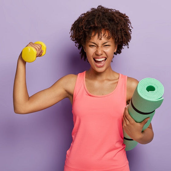 Woman with dumbbells and yoga mat