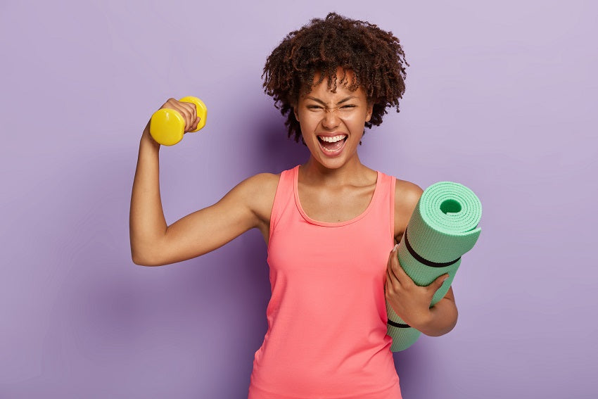 Woman with dumbbells and yoga mat
