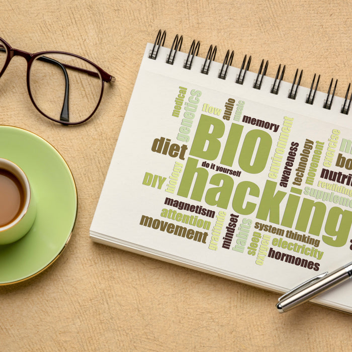 Biohacking diary, glasses and coffee cup on desk