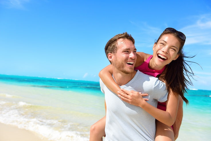 Healthy happy couple on beach